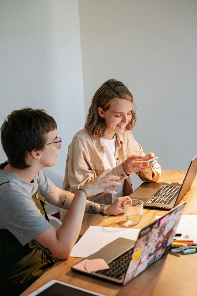 Women work on their computers while sitting side by side in the Workspace at Terra Square